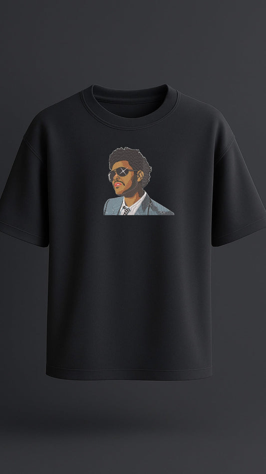 Black oversized t-shirt with premium embroidered design of The Weeknd, high-quality streetwear for men.