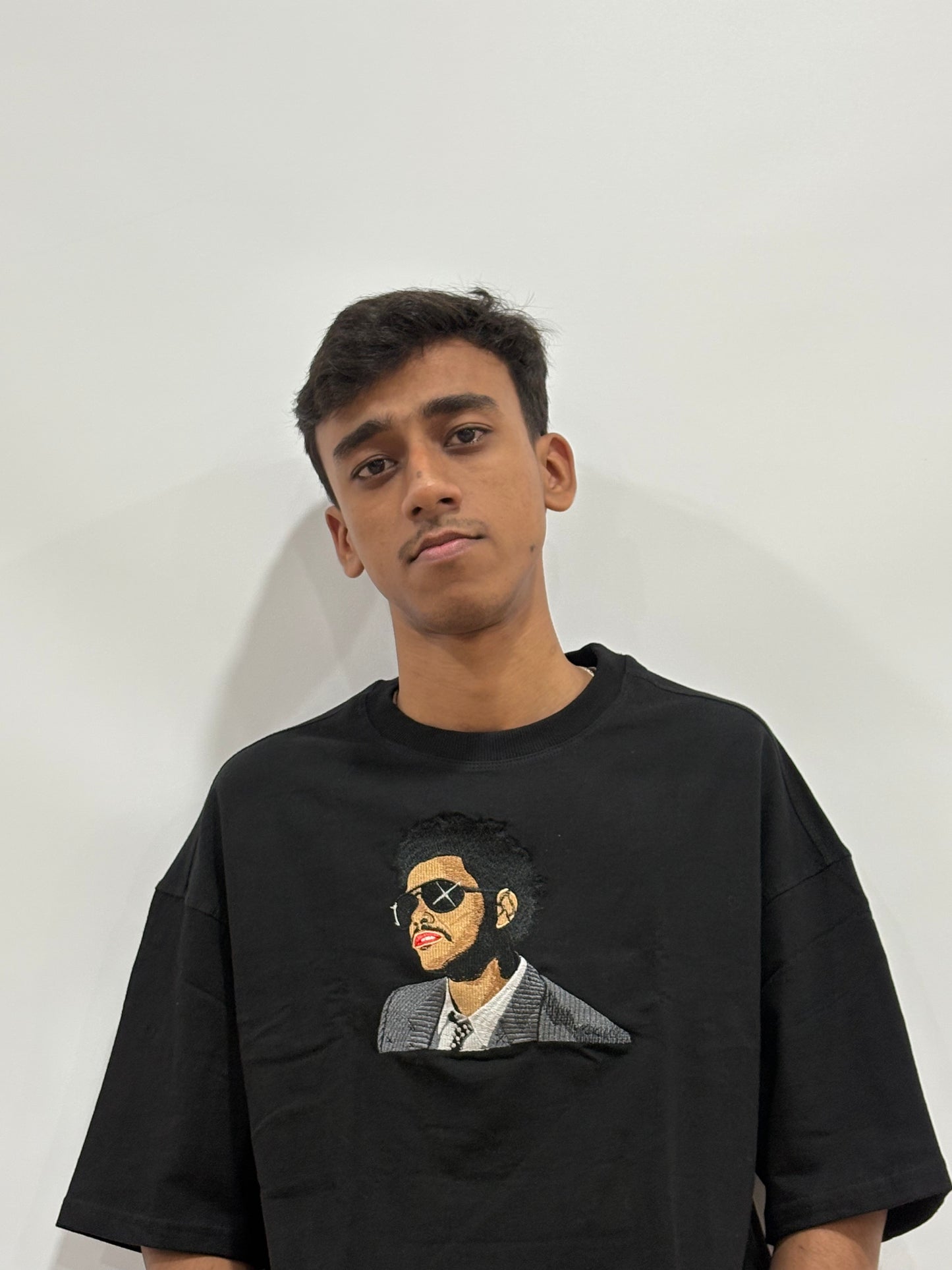 Black oversized t-shirt with premium The Weeknd embroidered design – Drip Saga luxury streetwear.