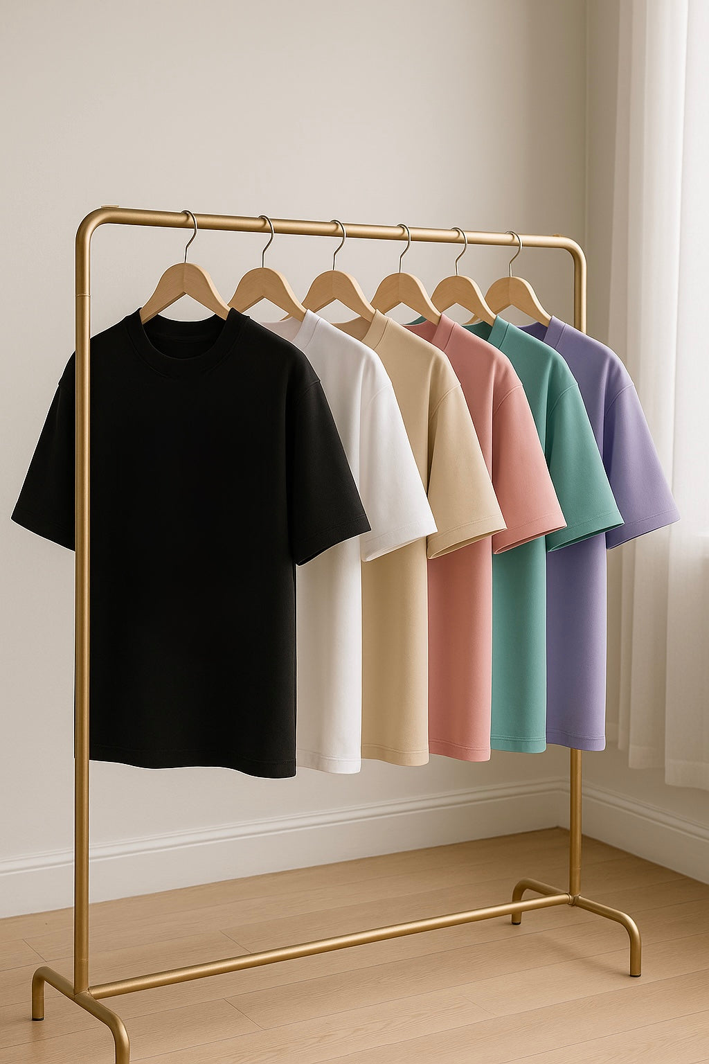 Premium oversized t-shirts in black, white, beige, baby pink, crystal teal, and lavender with embroidered designs, perfect for streetwear fashion.