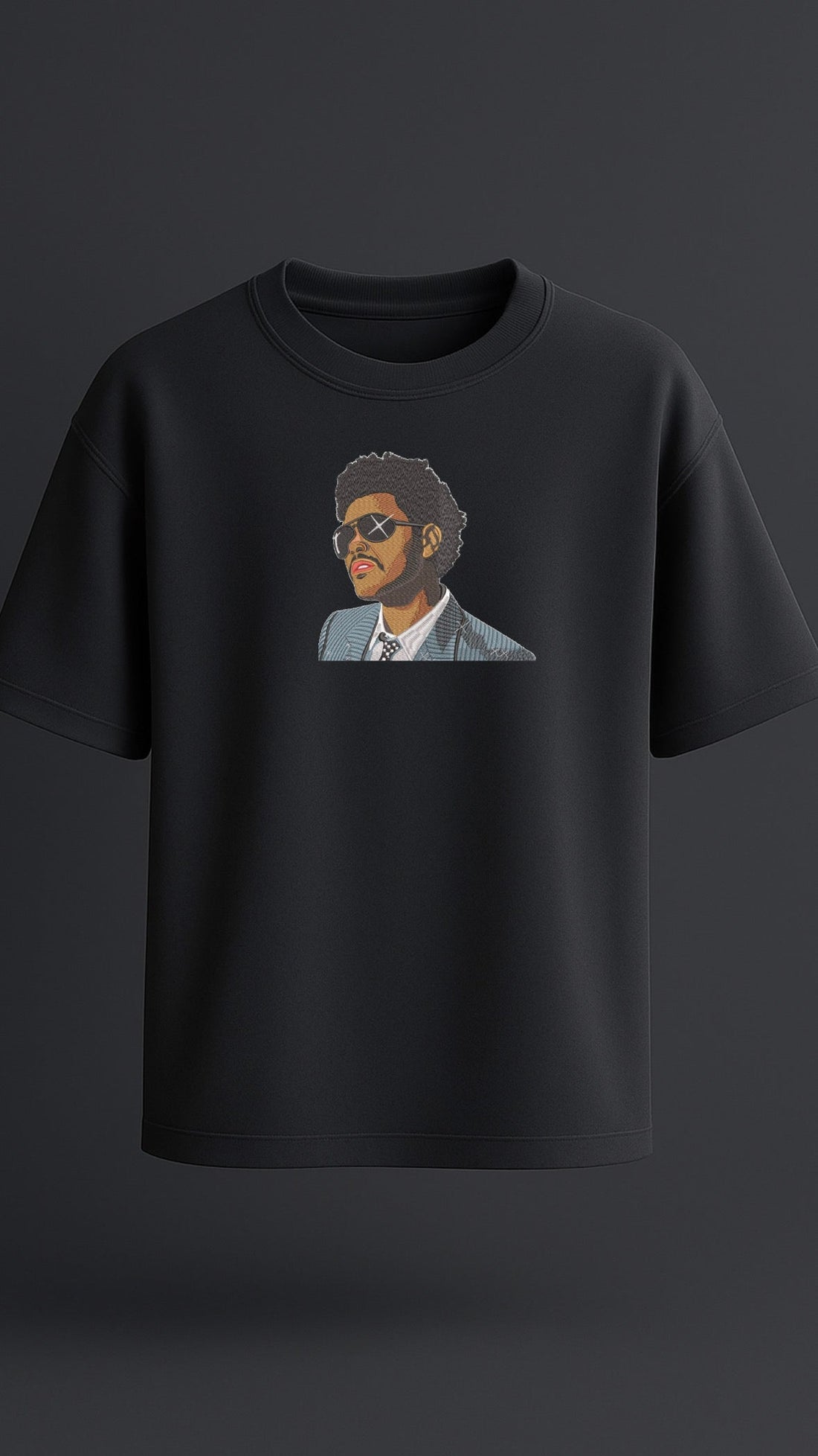 Black oversized t-shirt with premium embroidered design of The Weeknd, high-quality streetwear for men.