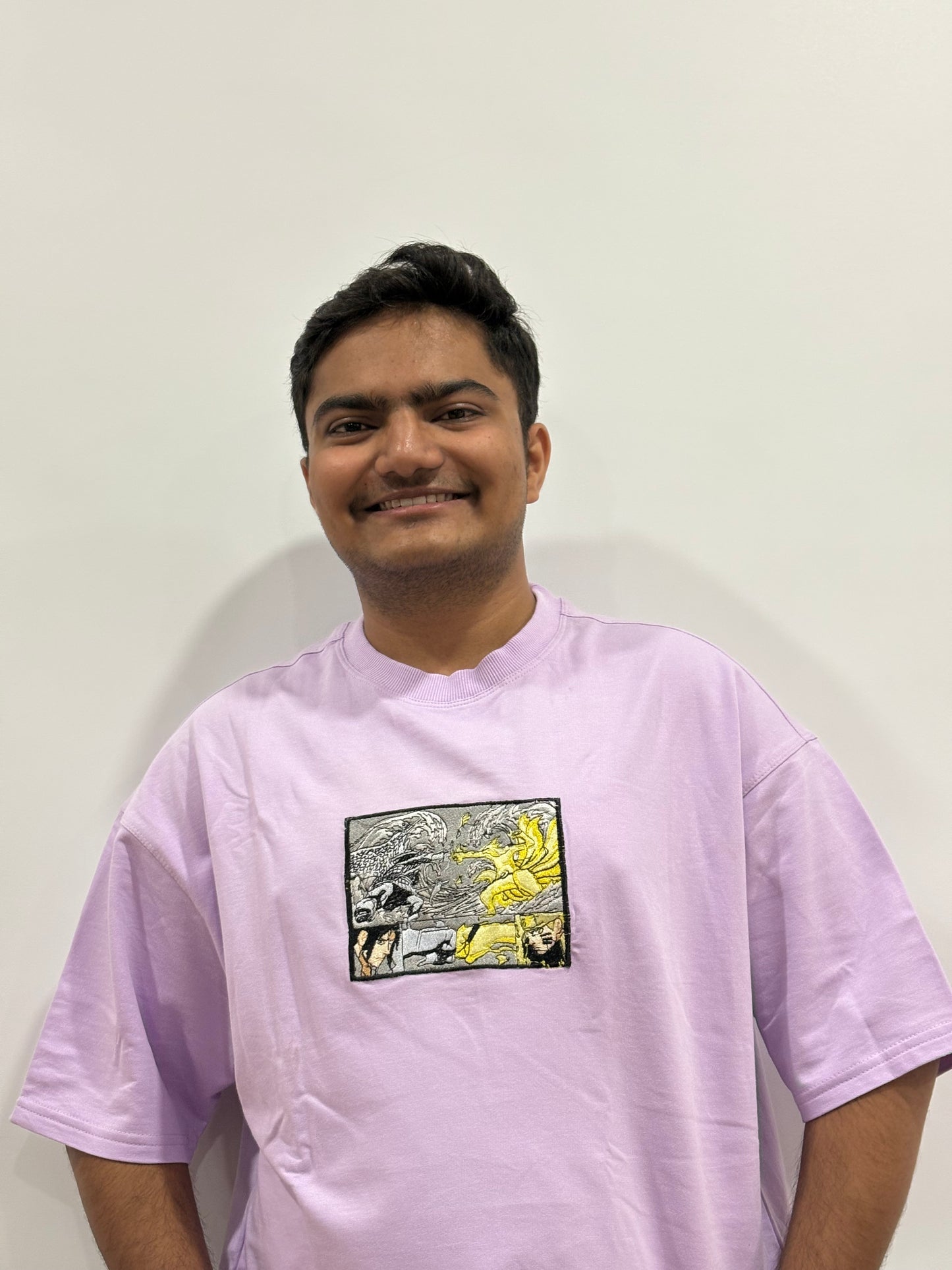 Lavender oversized t-shirt with premium Naruto vs Sasuke embroidery – Drip Saga anime streetwear.